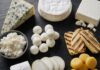 Erkennst du diese 10 Käsesorten? Auswahl verschiedener Käsesorten von Blauschimmel bis Hüttenkäse auf dunklem Schiefer